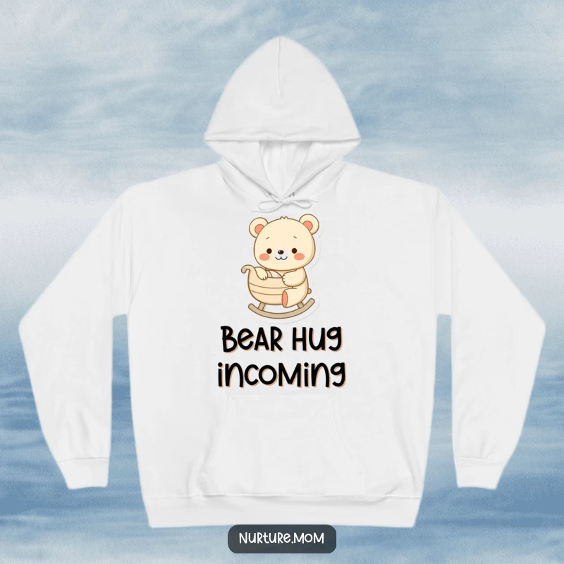 Funny hoodie with a cheerful bear character gently rocking a tiny cradle, embodying a humorous and peaceful scene of parental love.
