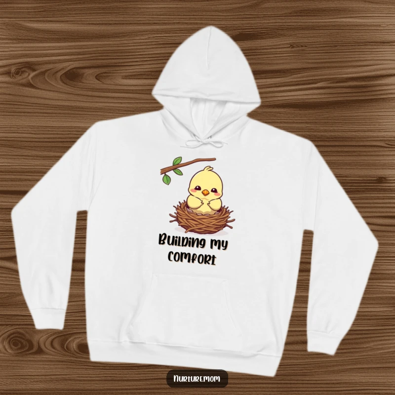 Funny kawaii mother bird building a cozy nest, featured on a cozy hoodie.