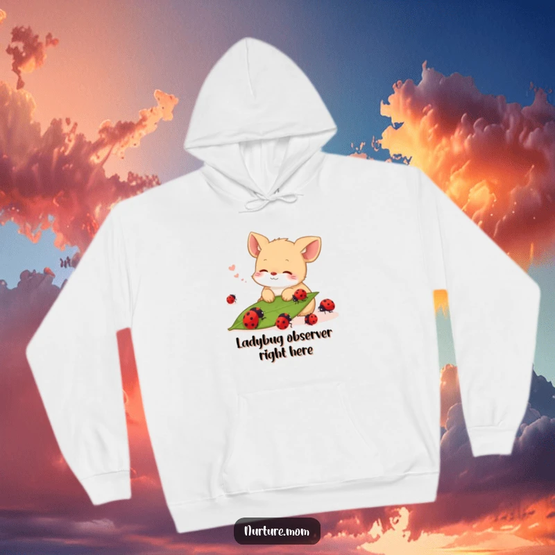 Funny hoodie depicting a small animal sighing contentedly while watching ladybugs crawl on a leaf, exuding comfort.