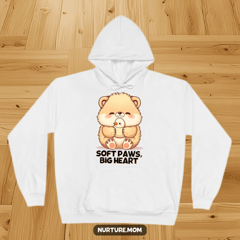 Funny hoodie features a fluffy creature gently holding a vulnerable baby bird in its paws, a heartwarming and humorous depiction of nurturing.