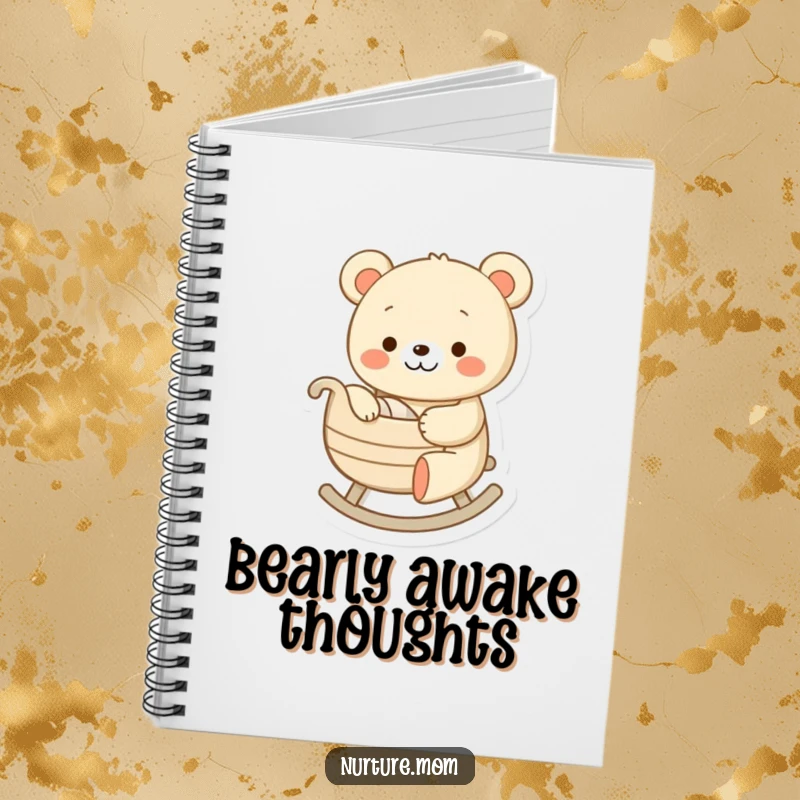 Funny notebook with a cheerful bear character gently rocking a tiny cradle, a humorous cover for journaling and note-taking.